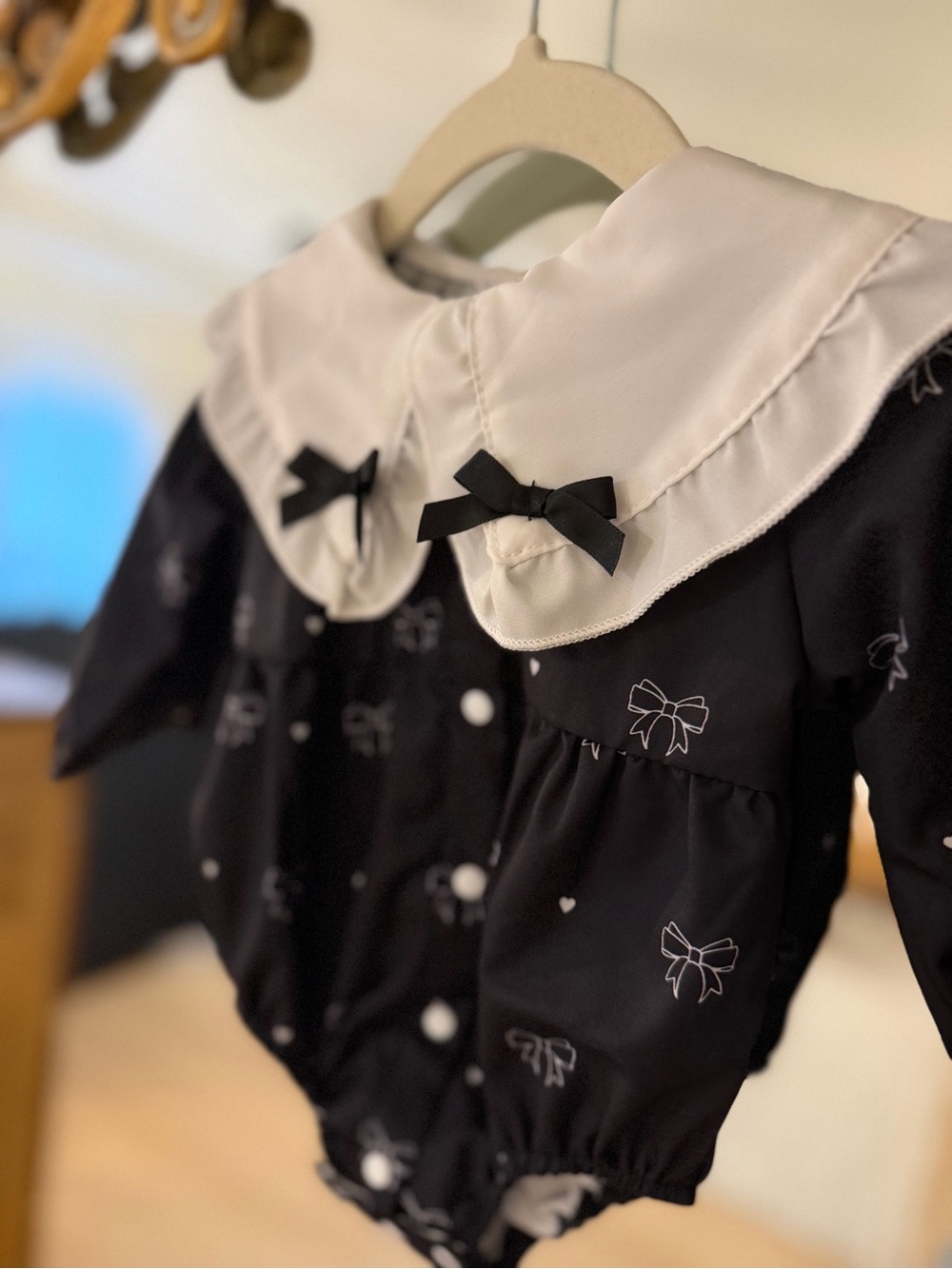 Black Bow-Print Baby Romper with White Peter Pan Collar